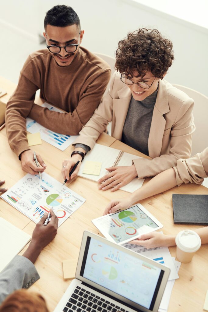 Home A diverse team of professionals collaborating over charts and graphs during a business meeting.